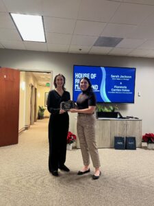 Gallagher Paralegal Morgan Miller being presented an award by Sarah Simmons, a Gallagher associate